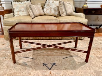 (A) WOOD & HOGAN MAHOGANY CHIPPENDALE STYLE COFFEE TABLE WITH PIERCED STRETCHER -42' BY 17' BY 19'
