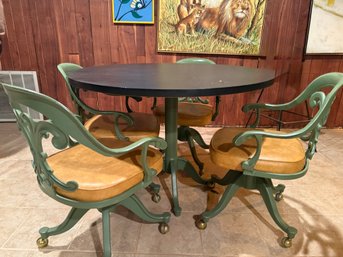 (BASE) MCM CAST IRON BASE GAME TABLE WITH MICA TOP & FOUR MATCHING CHAIRS ON WHEELS - 42' BY 29'H