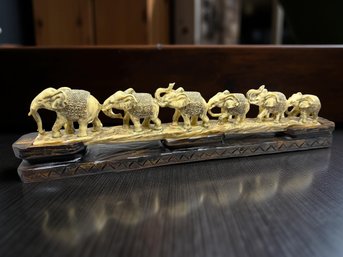 (A-36) VINTAGE CARVED ELEPHANT PARADE SCULPTURE ON A WOODEN BASE-APPROX. 17' X 4 1/2'