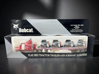 (A-41) VINTAGE NEW IN BOX-BOBCAT FLAT BED TRACTOR TRAILER-W/4 BOBCAT LOADERS-DIE CAST MODEL