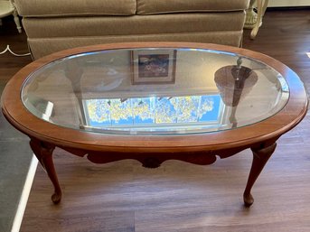 (LR) VINTAGE GLASS TOP CHERRY WOOD COFFEE TABLE, OVAL - 47' BY 32' BY 17'H