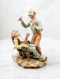 (A-63) VINTAGE PORCELAIN FIGURINE DEPICTING BARBER SHAVING CUSTOMER-MARKED BOTTOM