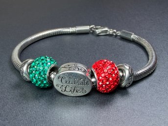 European Charm Bracelet Featuring A Central 'Celebrate Life' Charm Flanked By Red And Green Crystal Beads
