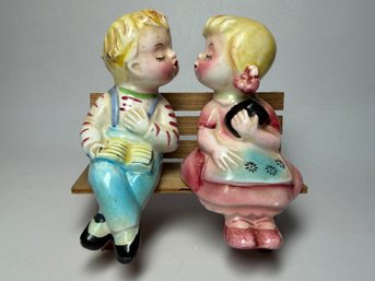 Vintage Mid-century Ceramic Salt And Pepper Shakers Depicting A Kissing Boy And Girl Sitting On A Wooden Bench
