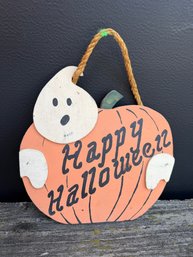 Rustic Wooden Cutout Hanging Sign Featuring A Ghost Overlapping An Orange Pumpkin
