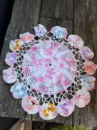 Hand-crocheted Decorative Doily Featuring A Textured White And Pink Center With A Colorful, Petal-edged Border