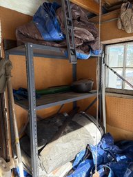 Metal Shelving Unit With Assorted Tools And Blue/Brown Tarps