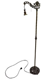 Cast Metal Floor Lamp With Ornate Arm And Twisted Pole Design
