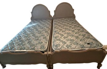 Twin Beds With Painted Wooden Frames And Matching Mattresses