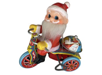 Vintage Tin Lithograph Wind-Up Santa Claus On Tricycle Toy With Composition Face And Fabric Beard