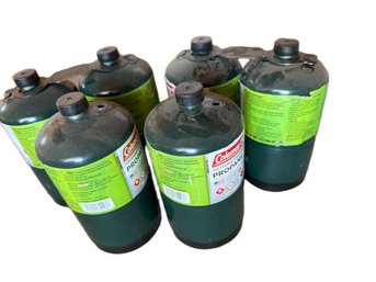 Six Coleman Propane Gas Canisters With Four Unopened And Two Partially Used