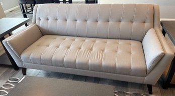 Gray Upholstered Sofa With Button Tufted Design