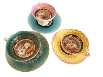 Three Porcelain Teacups And Saucers With Decorative Scenes, Marked 'FOZ'