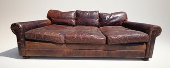 Three-Cushion Brown Leather Sofa With Rolled Arms