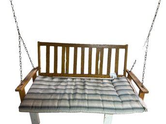 Wood Porch Swing With Striped Cushion And Chain Suspension