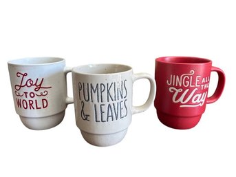 Set Of Three Holiday Ceramic Mugs With Seasonal Text