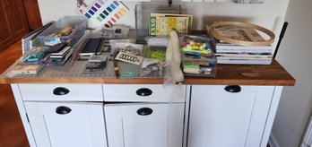 027 - ASSORTED CRAFT SUPPLIES, SEWING MATERIALS, AND ART TOOLS ON WHITE CABINET