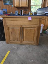 071 - WOODEN KITCHEN ISLAND CABINET WITH BLACK COUNTERTOP