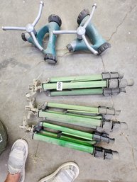 057 - SET OF GREEN ADJUSTABLE TRIPODS AND SPRINKLER BASES