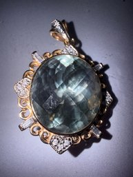 209 - 14KT YELLOW GOLD PENDANT WITH 19.75 NATURAL GREEN AMETHYST