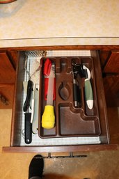 Kitchenorted Kitchen Utensils Including A Potato Masher, Bottle Brush, Can Opener, And Vegetable Peeler Utensi