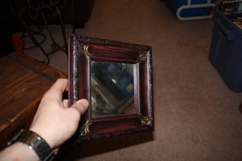 Victorian-Style Decorative Mirror With Dark Red Wood Frame And Gold Accents