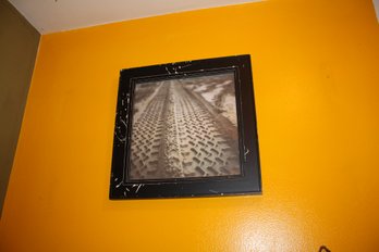Framed Artwork Featuring Tire Tracks