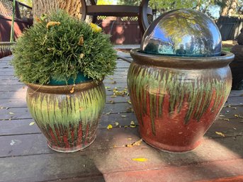 Two Glazed Ceramic Drip-pot Planters With Green Shrub And A Gazing Sphere