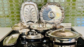 Assortment Of Silver-plated Serving Pieces, Which Include Trays, Bowls, Serving Utensils, And Covered Dishes