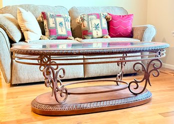 Traditional Oval Cocktail Table Featuring A Beveled Glass Insert Top And Ornate Bronze-tone Metal Scrollwork
