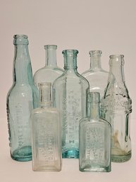7 Antique Vtg Embossed Glass Medicine Bottles