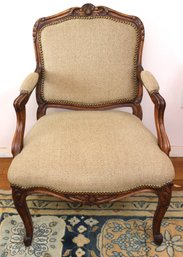 Vintage Louis XV Style Armchair Featuring Intricate Carvings And Light-Colored Upholstery
