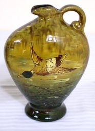 Weller Glazed Pitcher With A Colorful Duck In Flight Design.