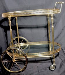 Vintage Art Deco Style Polished Brass Bar Cart With Pierced Brass Gallery, And 2 Glass Shelves.