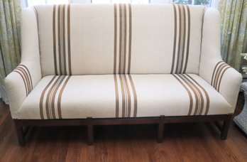 Tall Wing Back Settee Sofa With Wooden Legs &amp Nubby Linen Fabric Highlighted By Nail Heads.