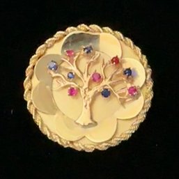 14K Yellow Gold Tree Of Life Pendant/Pin Decorated With Rubies And Sapphires And Rope Chain Border.