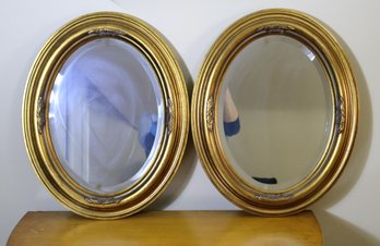Pair Of Oval Beveled Mirrors With Elegant Gold Frames From The Howard Elliot Collection.