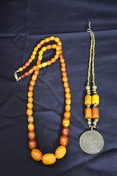 A Vintage Butterscotch Amber Graduated Bead Necklace And Another Ethnic Necklace