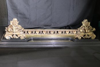 Antique French Bronze Fireplace Fender With Rams Heads And Grape Leaf Design Mounted On A Black Wooden Platfo
