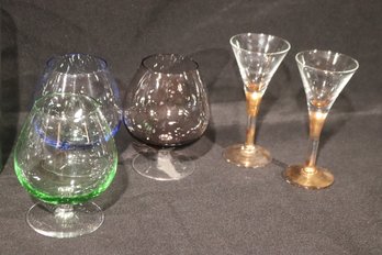 Assortment Of Colored Glassware With Brandy Sifters, And Lemonade Glasses.