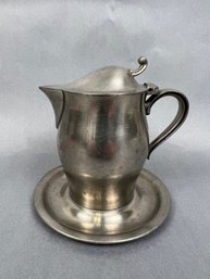 International Pewter Cream Pitcher With Attached Saucer.