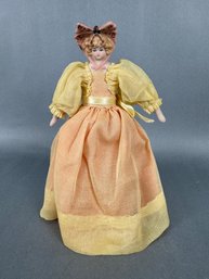 Small Doll With Porcelain Head  And Yellow Dress