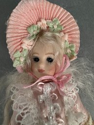 Small Porcelain Doll With Pink Clothes