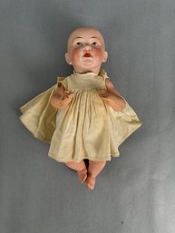 Small Bisque Baby Doll With Tan Dress Trimmed In Lace