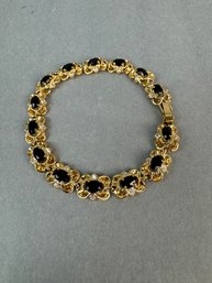 Dark Stone Bracelet On Gold Tone Setting
