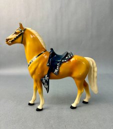 Tan Horse With Gray Saddle