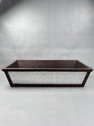 Rustic Wooden Planter Box Featuring Decorative Metal Paneling
