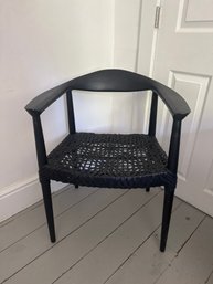 SAFAVIEH Bandelier Arm Chair Featuring A Black Teak Wood Frame And A Woven Black Leather Seat.