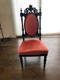 Antique 19th-century Ebonized Side Chair With Ornate Carved Wooden Crest And Vibrant Red Velvet Upholstery