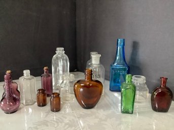 An Assortment Of Colored Glass Including Lab Glassware